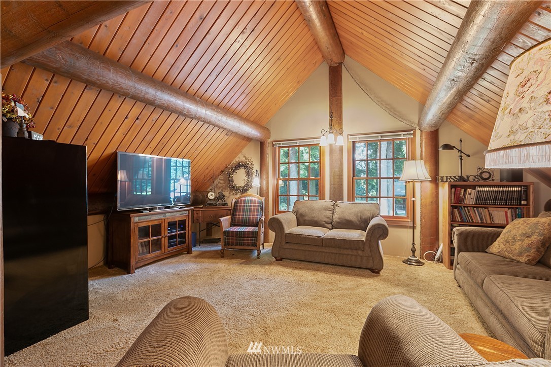 698 West Pole Road Ferndale, WA 98248 - Photo 40 of 40 a bedroom with furniture a flat screen tv and a refrigerator