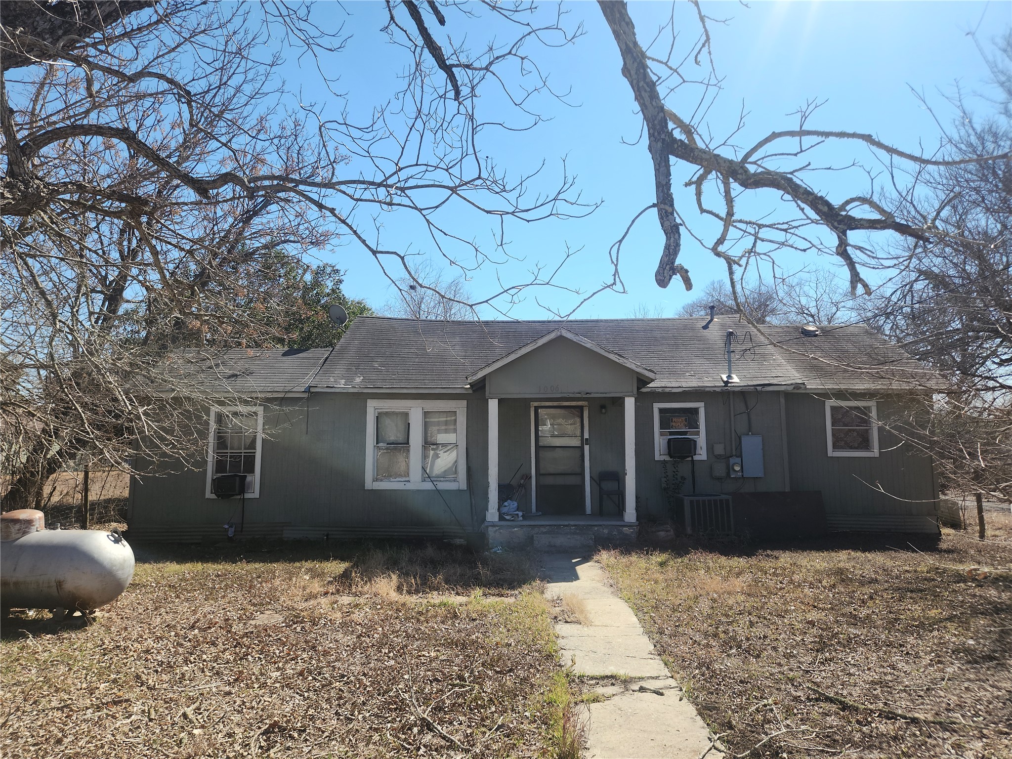 View of front of home with a shingled roof and a porch