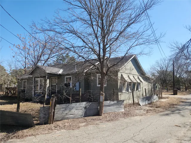 a view of a house with a yard covered in snow
