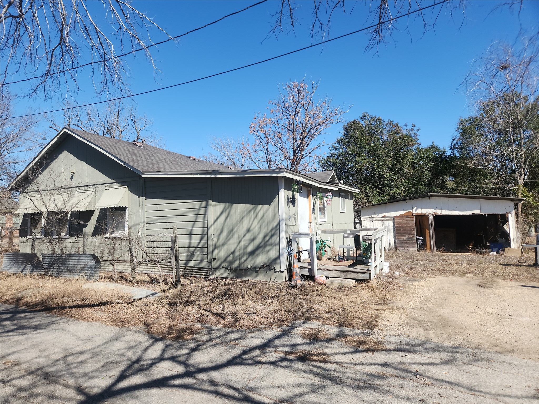 1006 Proctor Street Lockhart, TX 78644 - Photo 4 of 8 View of property exterior with a deck and a detached garage