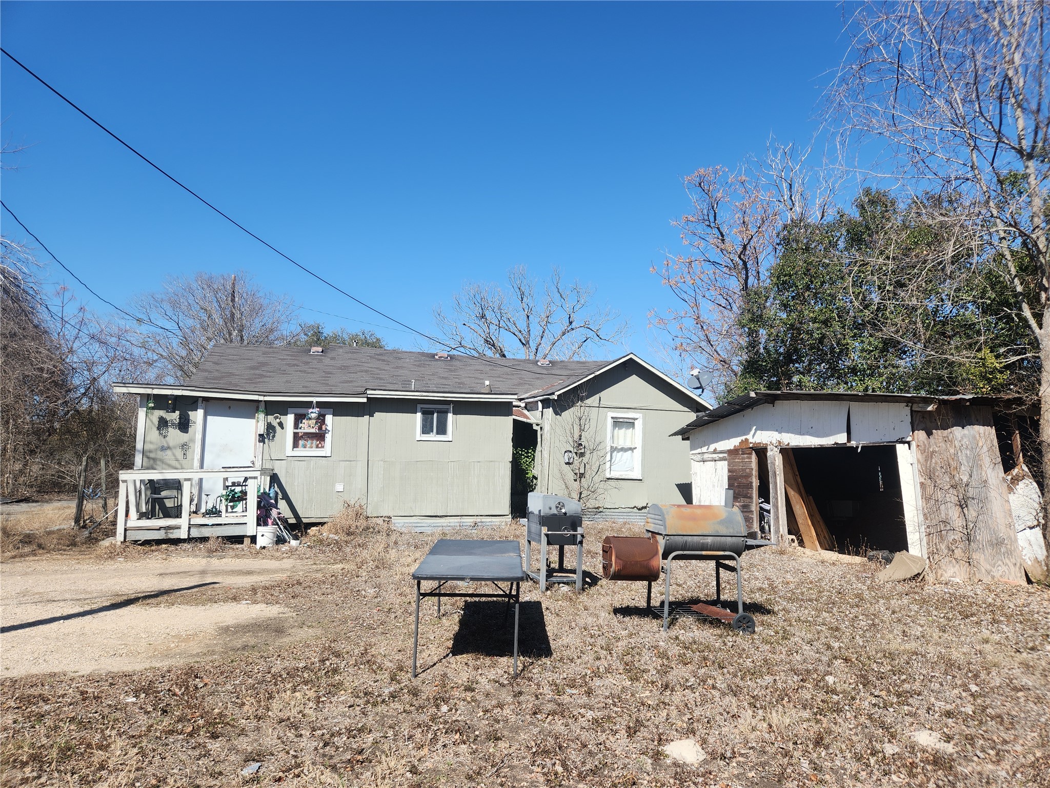 1006 Proctor Street Lockhart, TX 78644 - Photo 6 of 8 Rear view of house featuring a storage shed and a patio