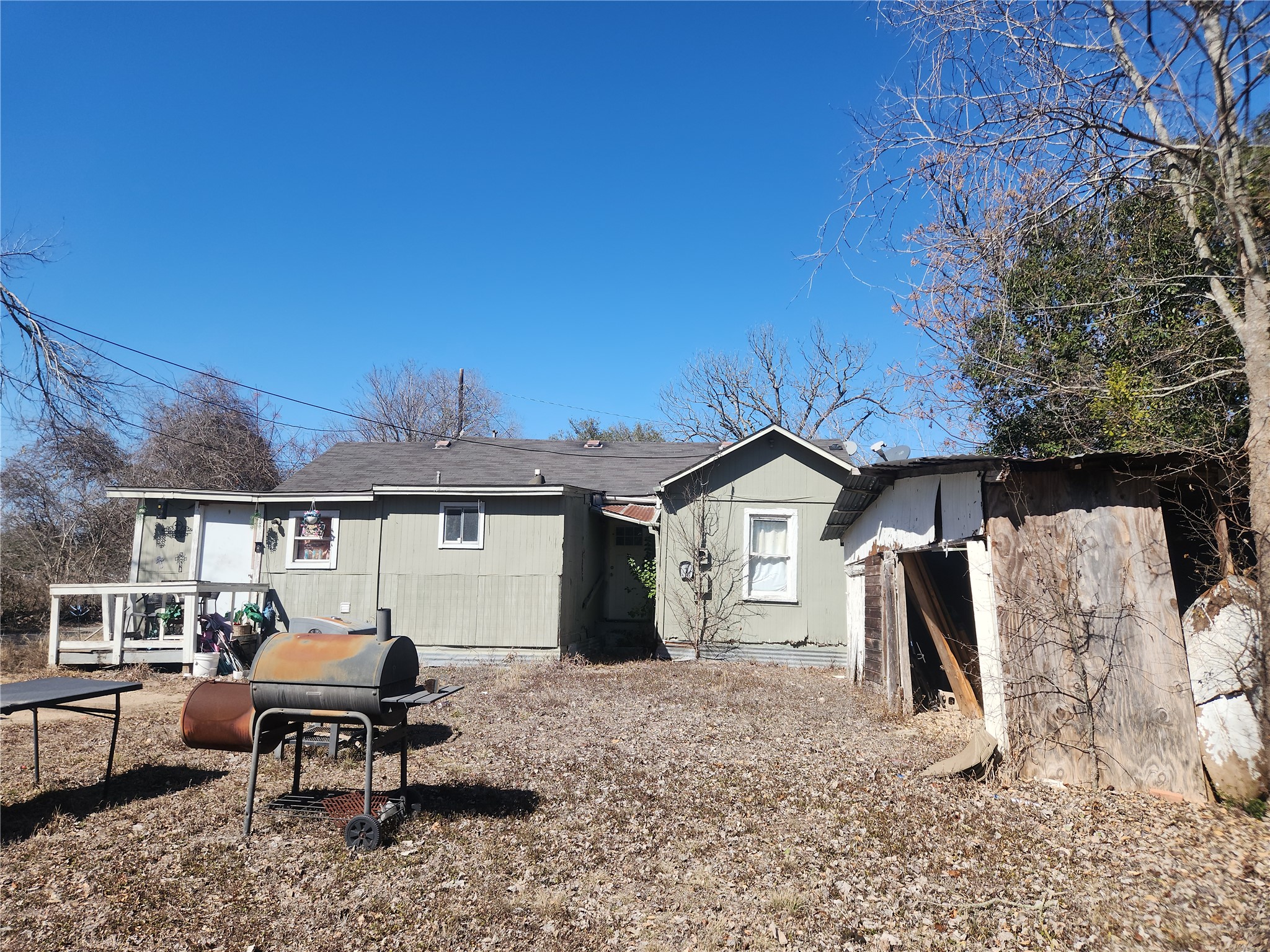 1006 Proctor Street Lockhart, TX 78644 - Photo 7 of 8 Back of house featuring a shingled roof