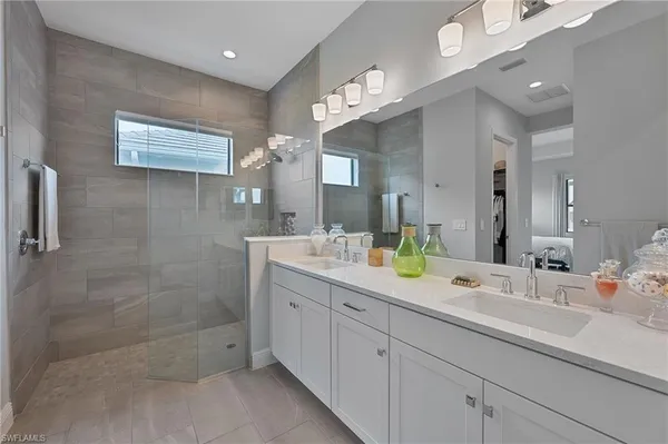 a bedroom with furniture and a large window