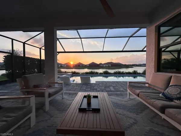 a view of a roof deck with couches and potted plants