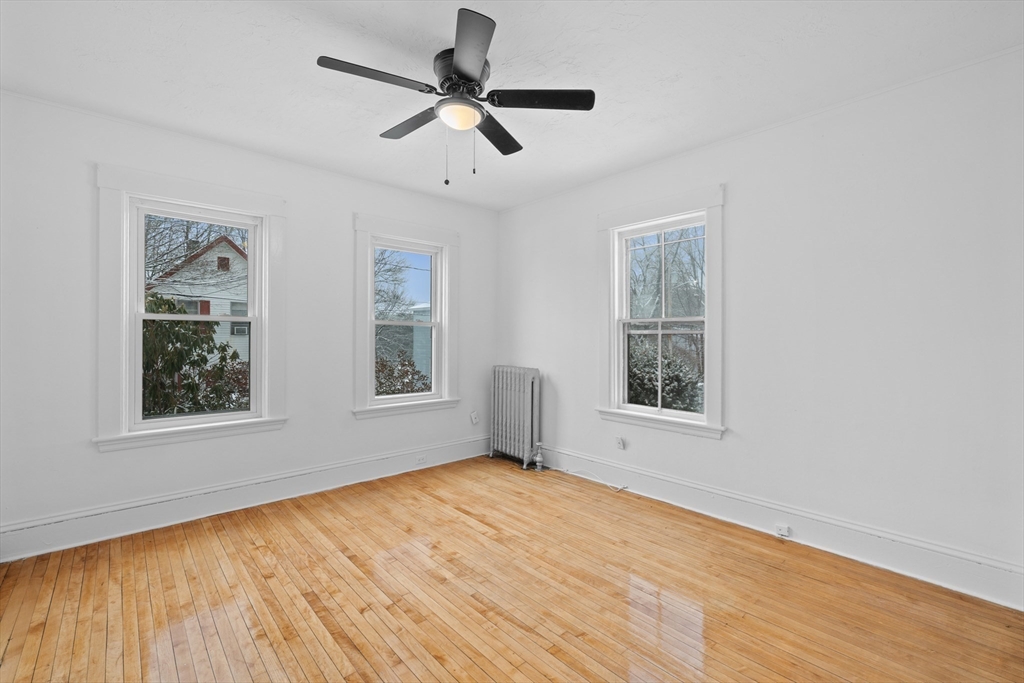 20 Temple Street, Unit 1 Fitchburg, MA 01420 - Photo 1 of 25 a view of an empty room with a window and wooden floor