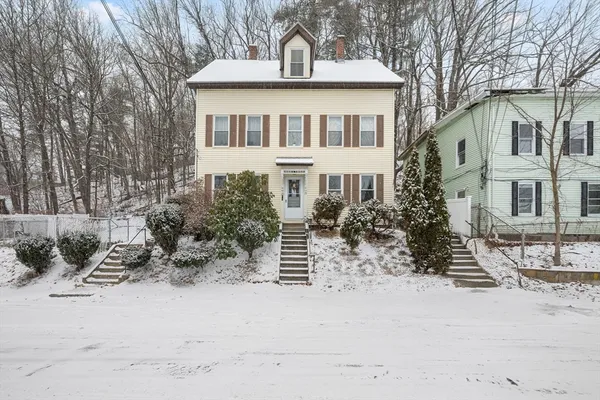 a front view of a house with a yard