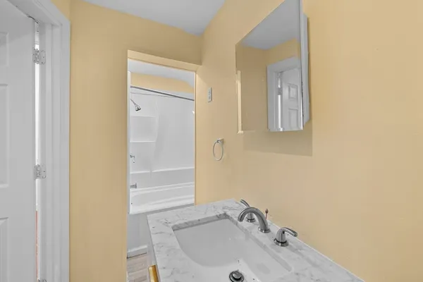 a bathroom with a sink and a mirror