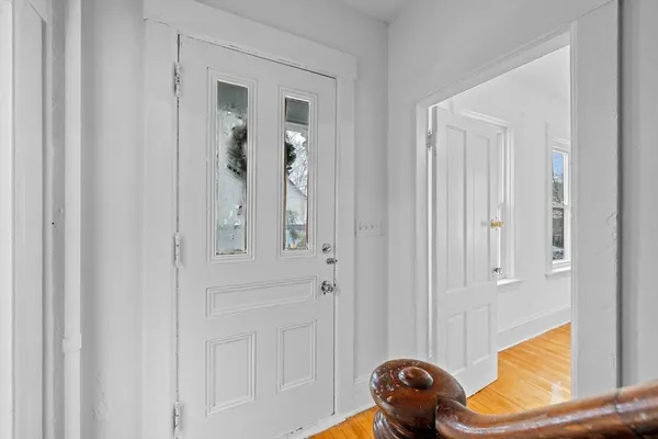 a view of a entryway door with wooden floor