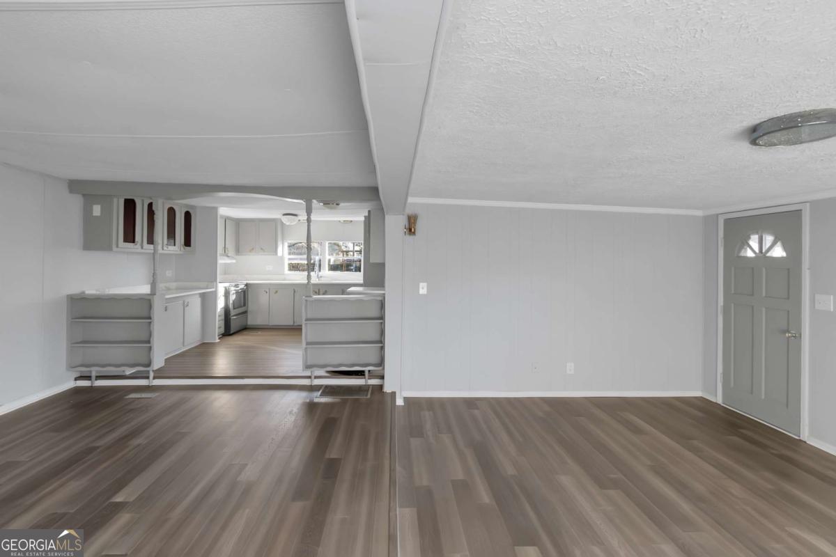 24 David Drive Hampton, GA 30228 - Photo 12 of 21 an empty room with wooden floor and windows