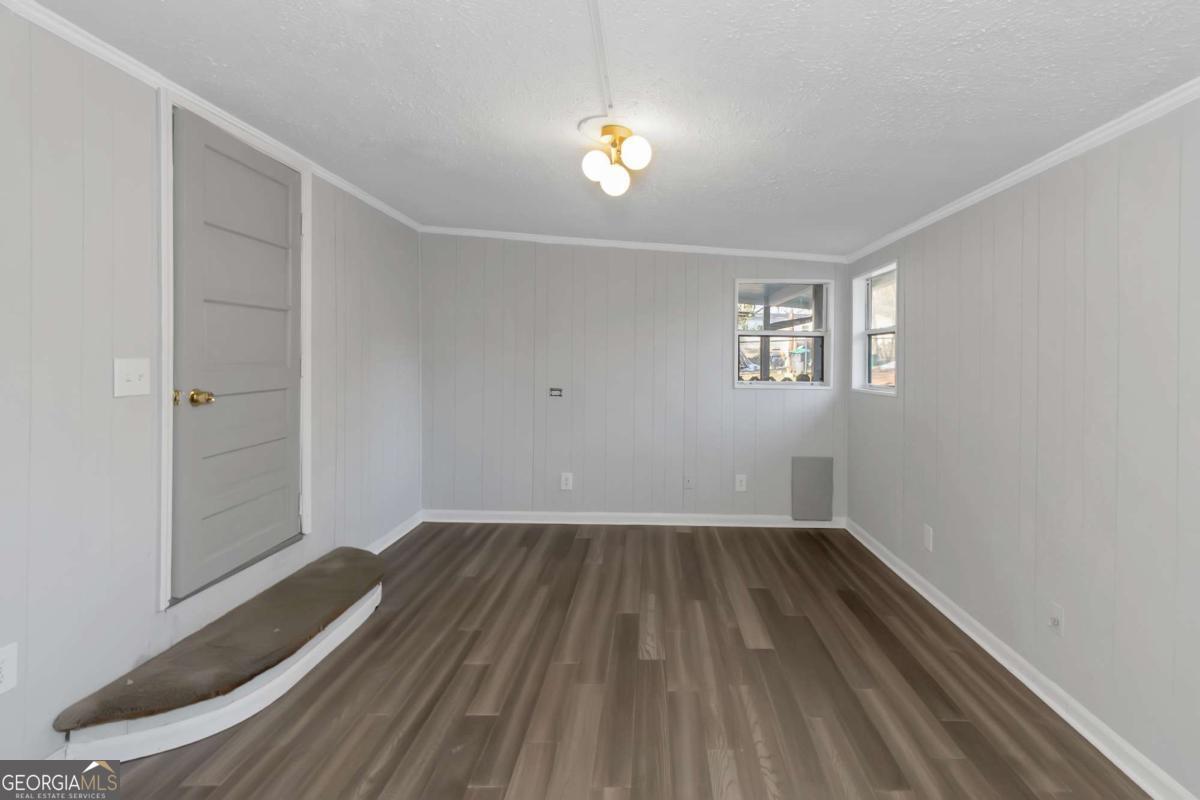 24 David Drive Hampton, GA 30228 - Photo 14 of 21 wooden floor in an empty room with a window