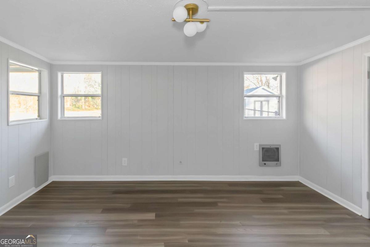 24 David Drive Hampton, GA 30228 - Photo 15 of 21 a view of empty room with window and wooden floor