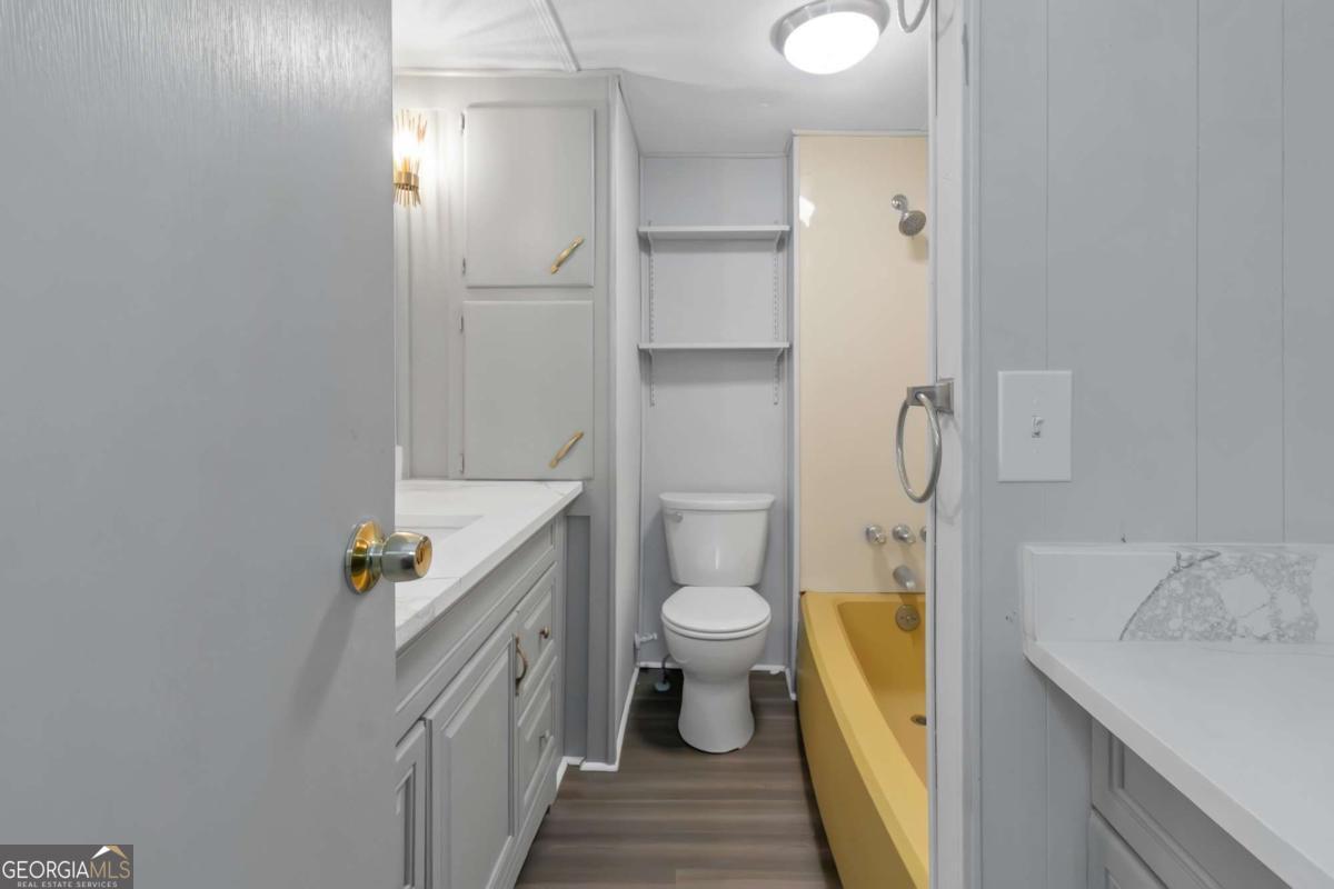 24 David Drive Hampton, GA 30228 - Photo 18 of 21 a bathroom with a sink a toilet and shower