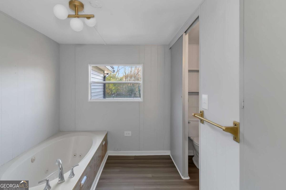 24 David Drive Hampton, GA 30228 - Photo 21 of 21 a bathroom with a tub and a shower