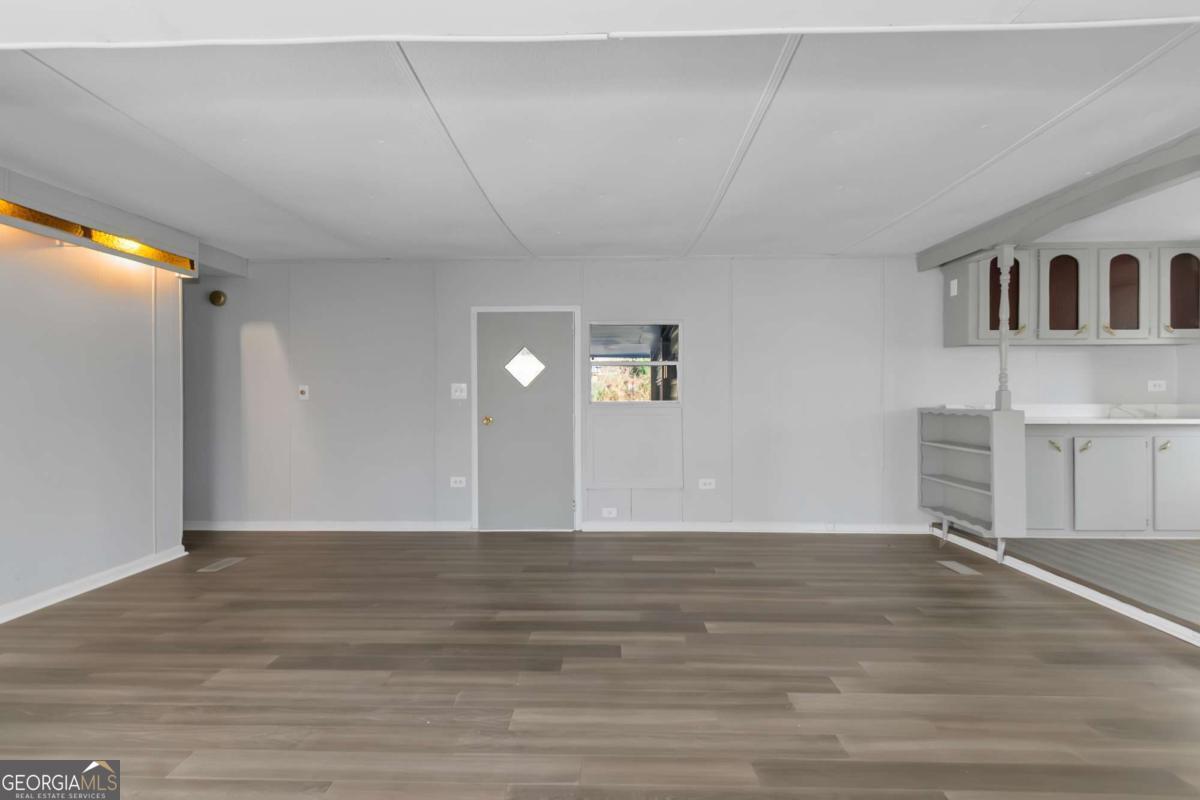24 David Drive Hampton, GA 30228 - Photo 7 of 21 a view of a livingroom with wooden floor