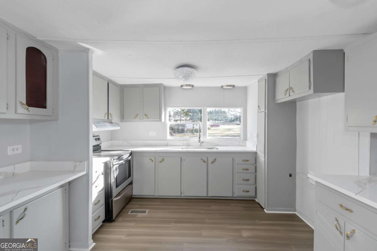24 David Drive Hampton, GA 30228 - Photo 9 of 21 a spacious bathroom with a granite countertop sink and a mirror
