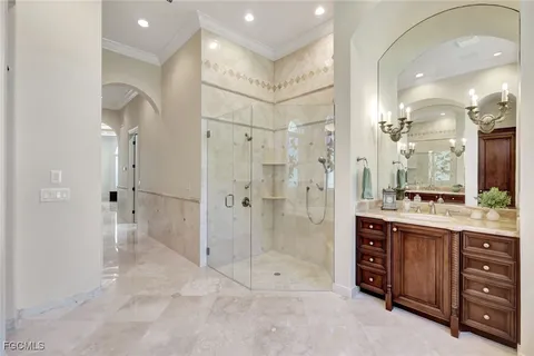 a bathroom with a granite countertop sink a toilet a mirror and shower