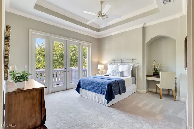 a living room with lots of tables a large window and furniture