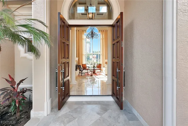a view of a hallway with entryway wooden floor and front door