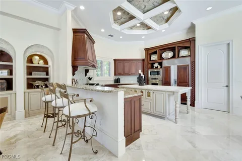 a kitchen with a cabinets and chandelier