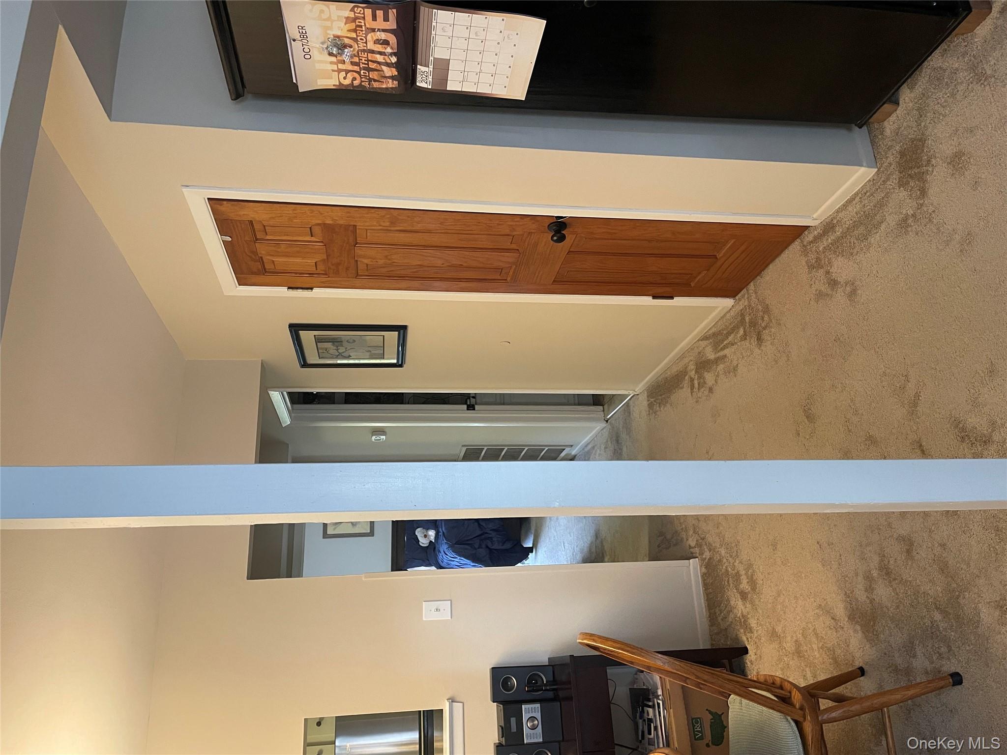 81 Rocky Point Yaphank Road, Unit 145 Rocky Point, NY 11778 - Photo 4 of 11 Hall with light carpet and an office area