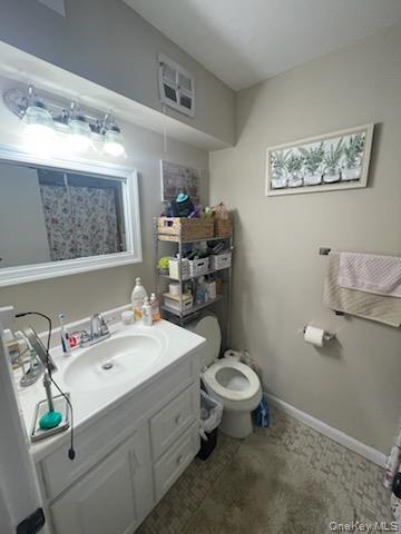 81 Rocky Point Yaphank Road, Unit 145 Rocky Point, NY 11778 - Photo 5 of 11 a bathroom with a sink mirror vanity and toilet
