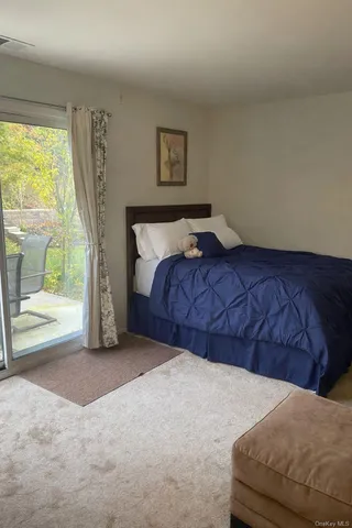 a bed sitting in a bedroom next to a window