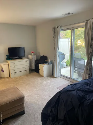 a bedroom with a bed and large window