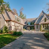 a front view of a house with a yard and trees