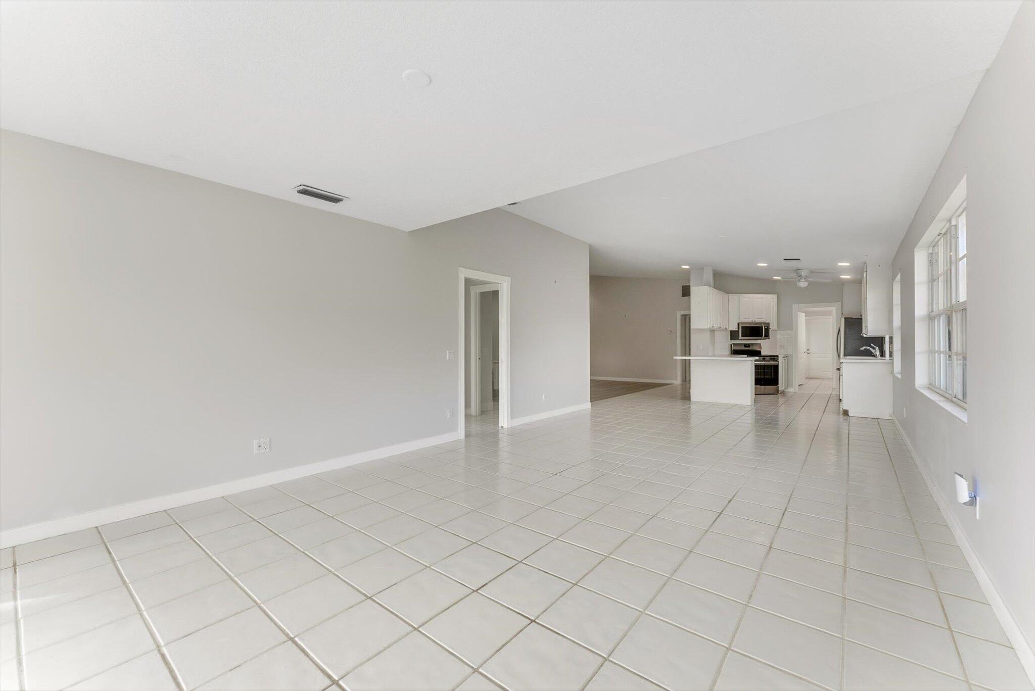 2162 Blue Springs Road West Palm Beach, FL 33411 - Photo 13 of 42 a view of a kitchen with a sink and a refrigerator