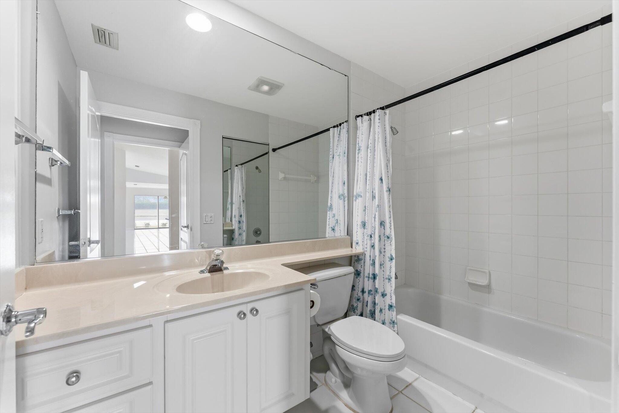 2162 Blue Springs Road West Palm Beach, FL 33411 - Photo 21 of 42 a bathroom with a double vanity sink toilet mirror and bathtub