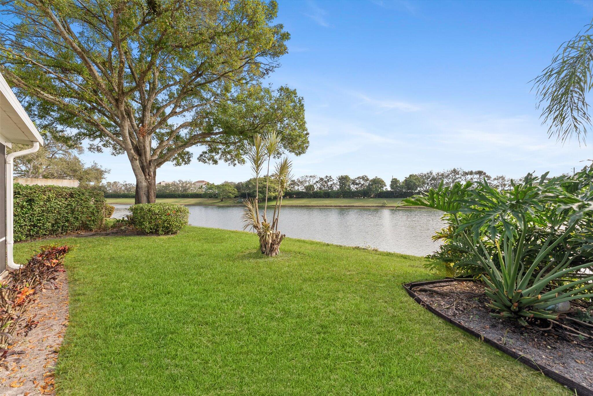 2162 Blue Springs Road West Palm Beach, FL 33411 - Photo 31 of 42 a view of a lake with a garden