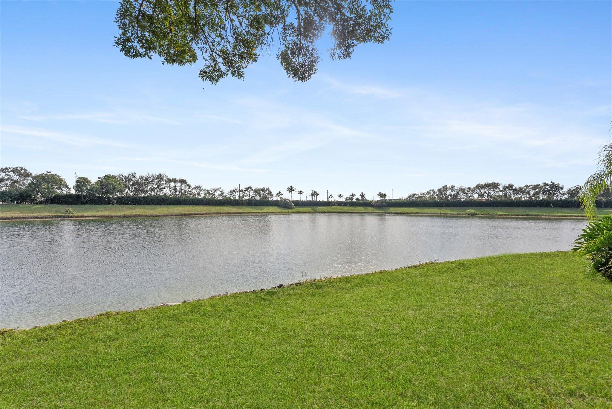 2162 Blue Springs Road West Palm Beach, FL 33411 - Photo 32 of 42 a view of a lake with houses in the back