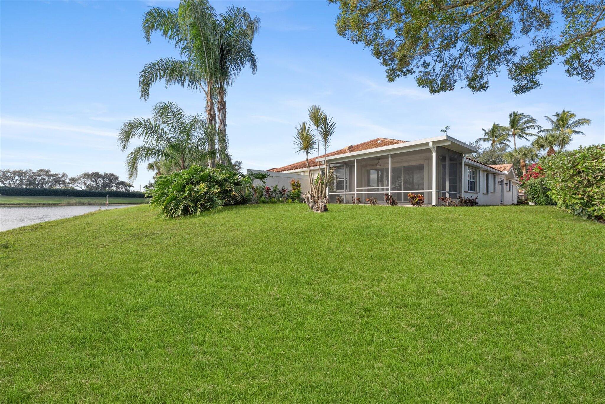 2162 Blue Springs Road West Palm Beach, FL 33411 - Photo 33 of 42 a view of a house with a yard and a garden