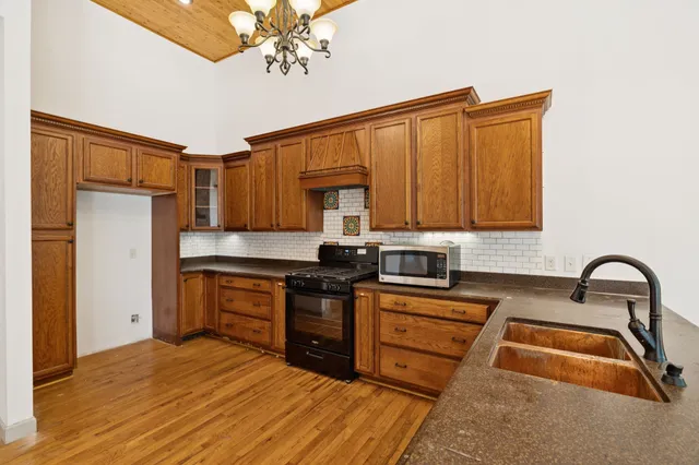 a view of an empty room and window and wooden floor