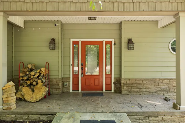 a view of an entryway with wooden floor