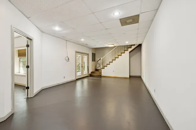 a view of a house with a yard and large tree