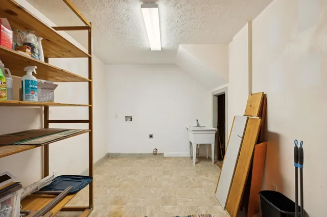 an aerial view of a house with a yard and lake view