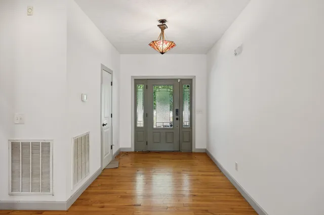 a living room with a fireplace and a wooden floor