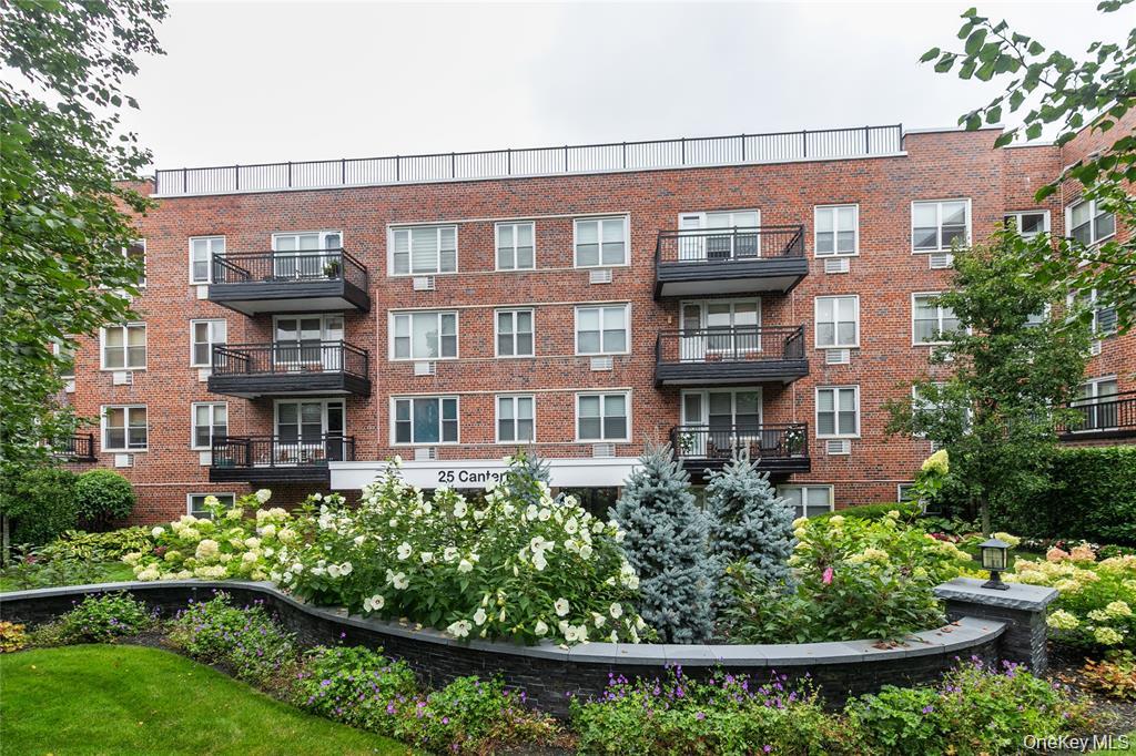 25 Canterbury Road, Unit 2F Great Neck, NY 11021 - Photo 23 of 23 a front view of a building with a garden
