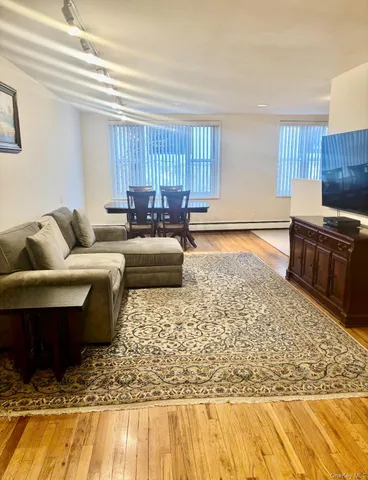 a living room with furniture window and wooden floor