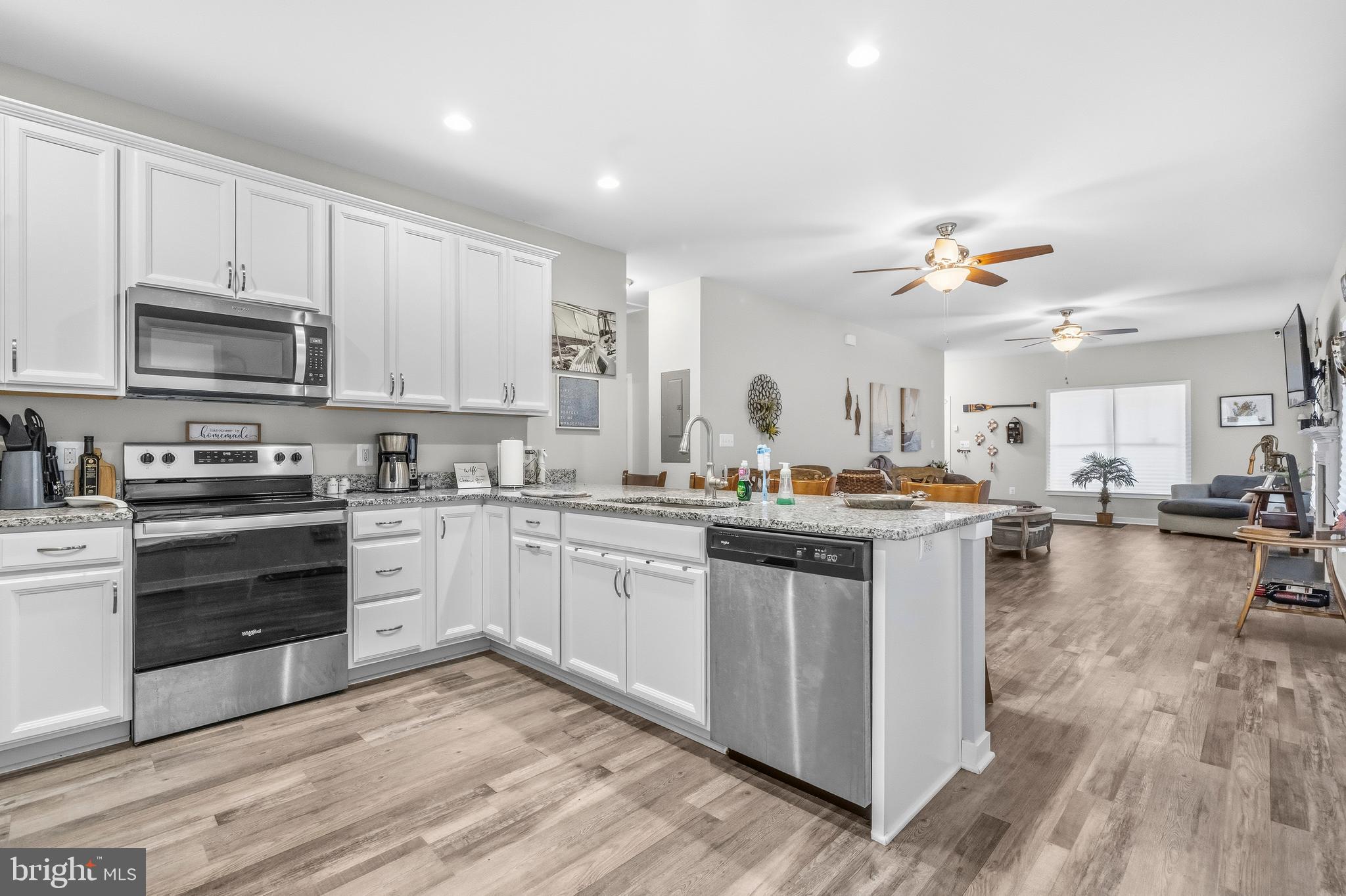 324 3rd Street Colonial Beach, VA 22443 - Photo 11 of 37 a kitchen with kitchen island granite countertop a sink cabinets and stainless steel appliances