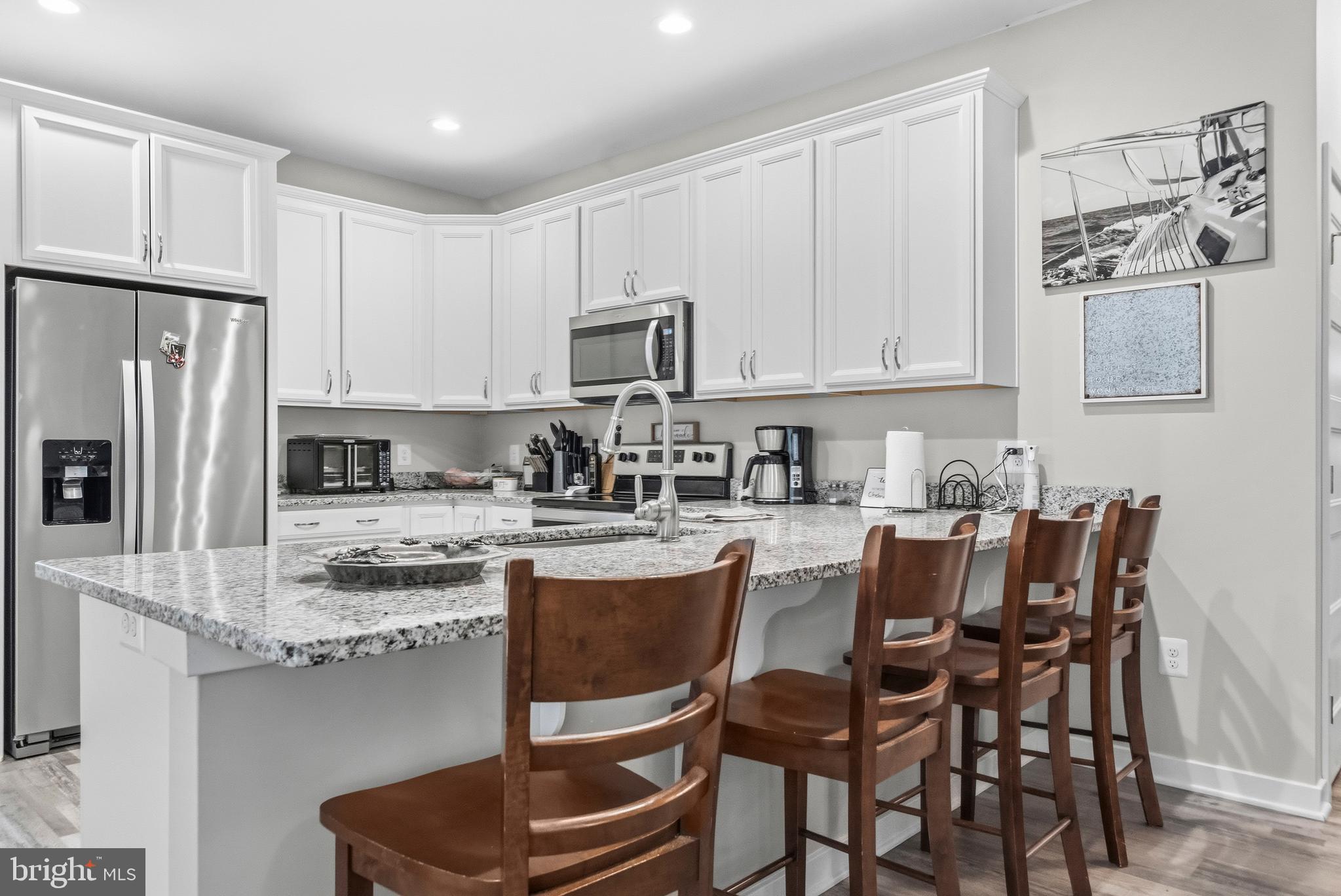 324 3rd Street Colonial Beach, VA 22443 - Photo 16 of 37 a kitchen with stainless steel appliances granite countertop a stove refrigerator sink and cabinets