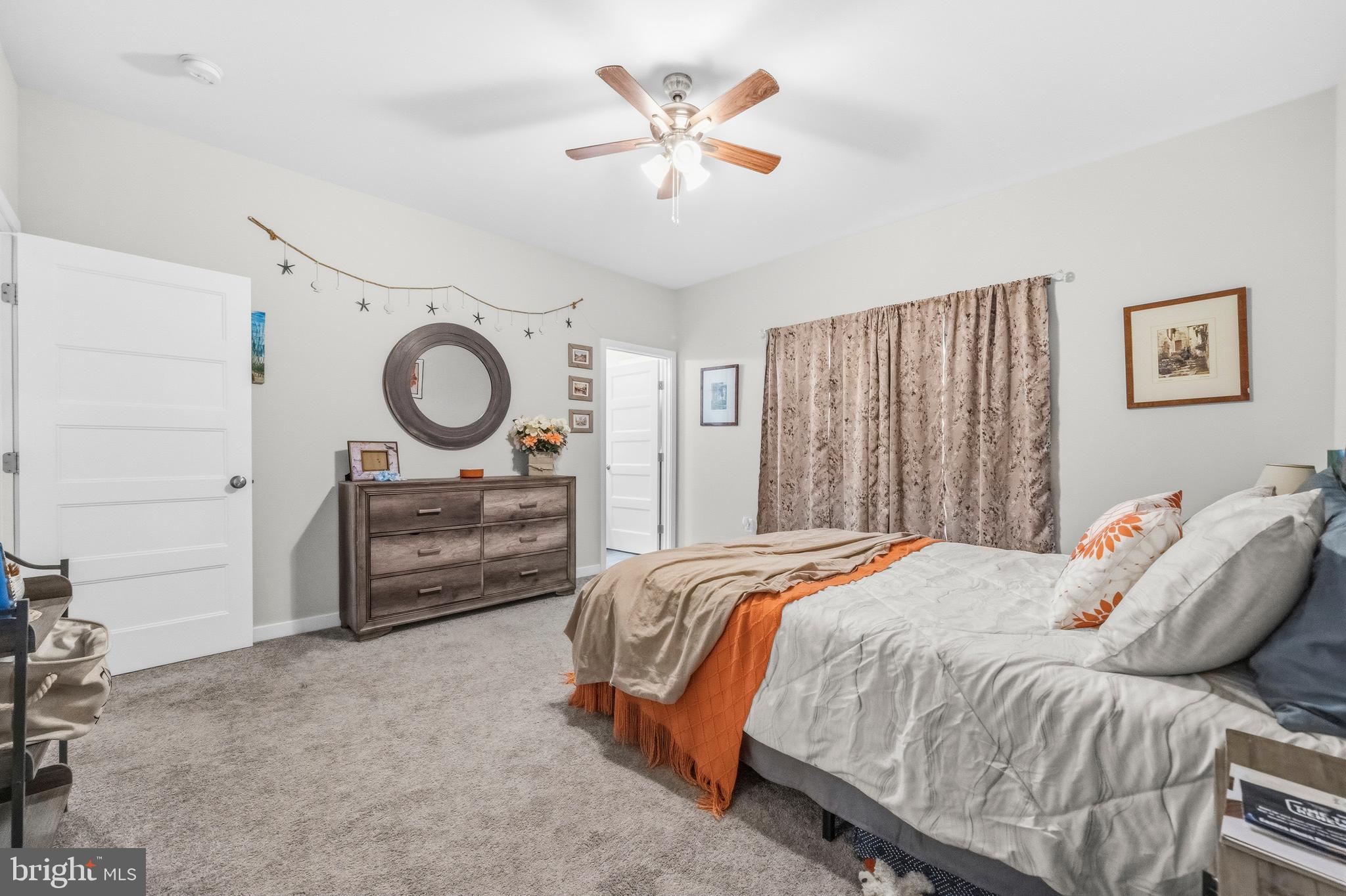 324 3rd Street Colonial Beach, VA 22443 - Photo 18 of 37 a bedroom with a bed and a chandelier
