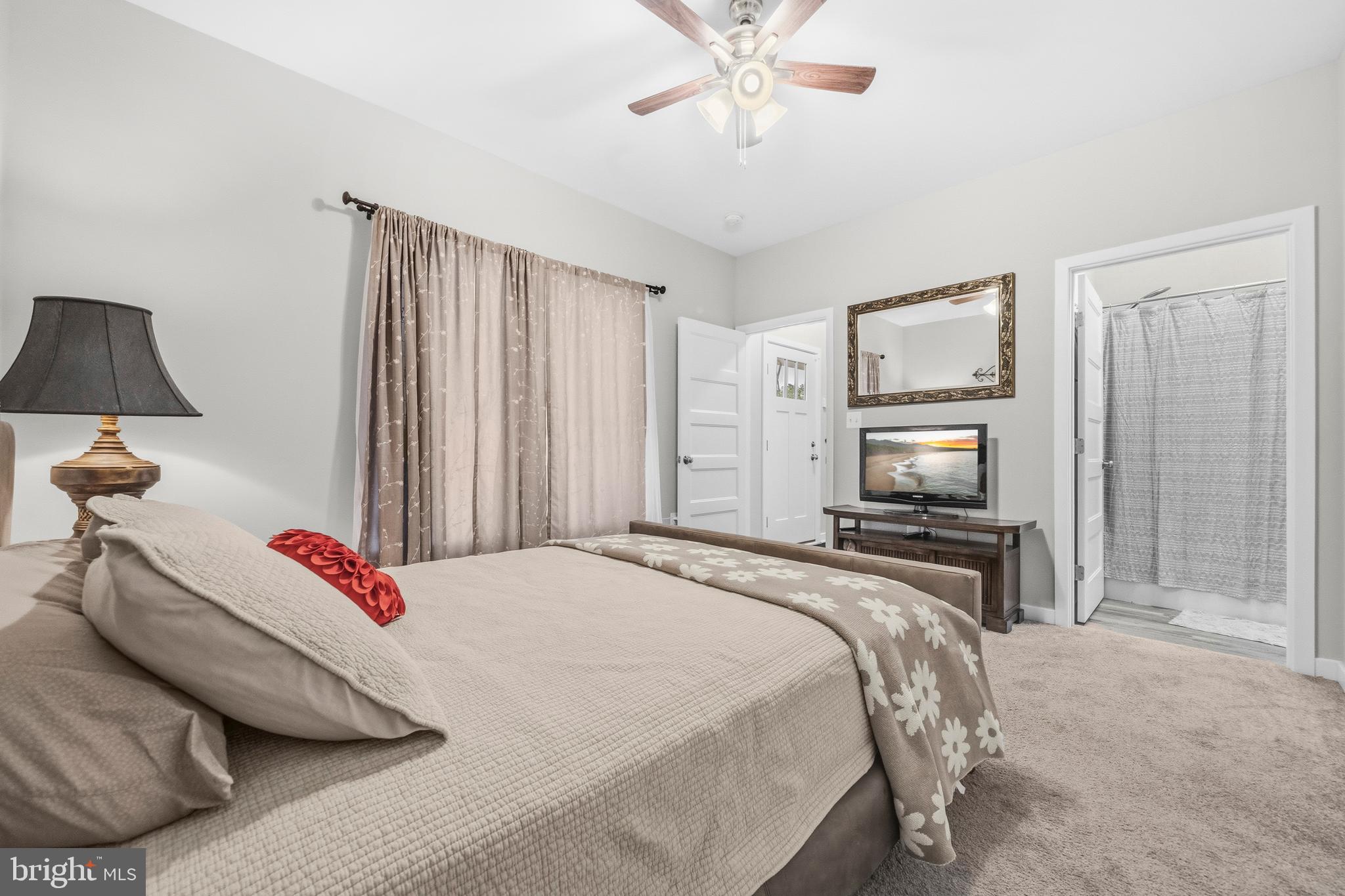 324 3rd Street Colonial Beach, VA 22443 - Photo 22 of 37 a bedroom with a bed and a flat screen tv