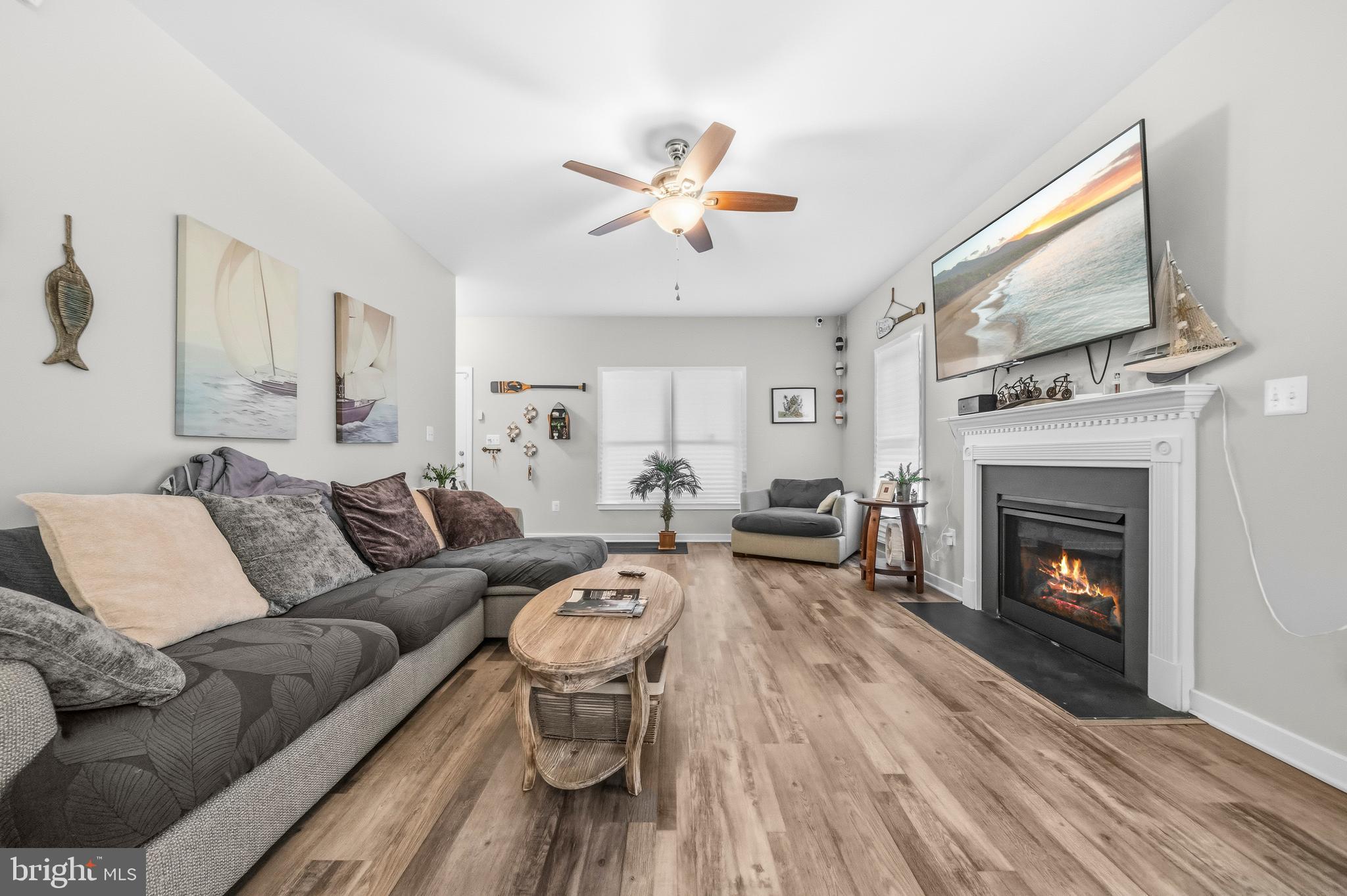 324 3rd Street Colonial Beach, VA 22443 - Photo 7 of 37 a living room with furniture a fireplace and a flat screen tv