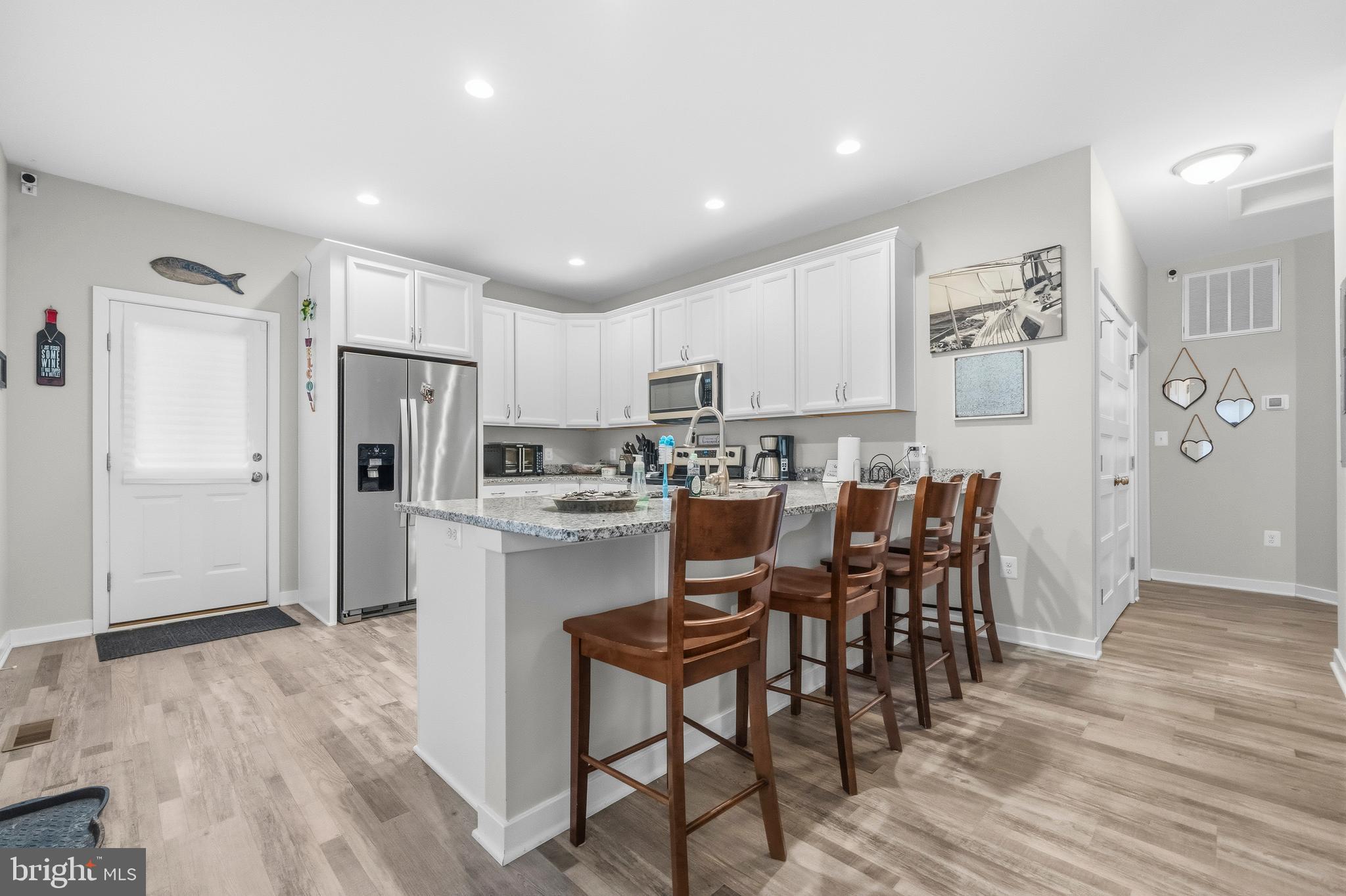 324 3rd Street Colonial Beach, VA 22443 - Photo 10 of 37 a kitchen with refrigerator cabinets and wooden floor