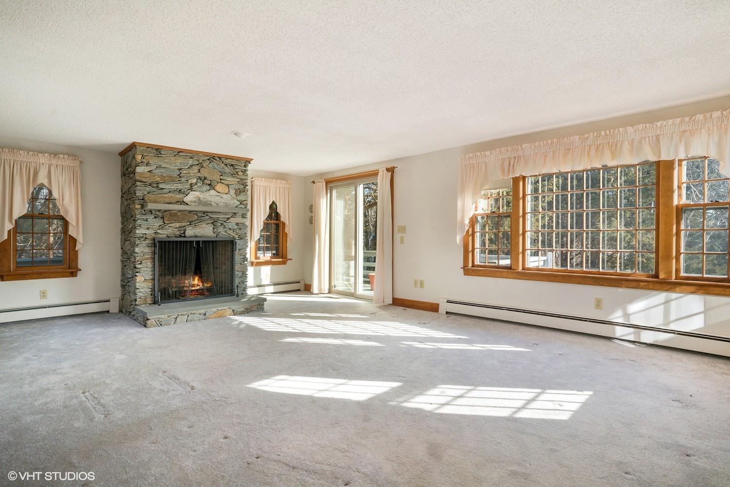 26 Point Hill Road West Barnstable, MA 02668 - Photo 11 of 23 a view of an empty room with a fireplace and a window