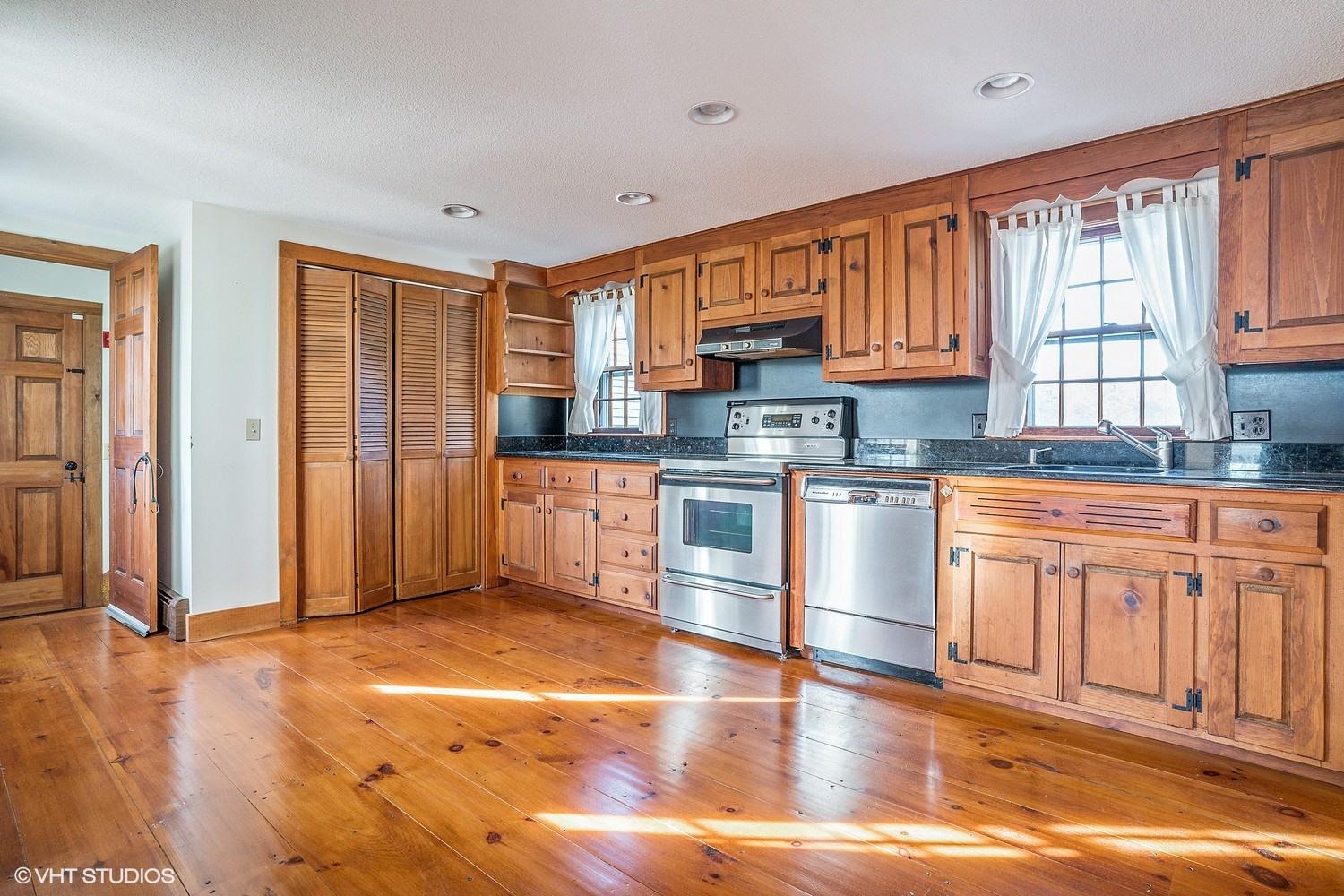 26 Point Hill Road West Barnstable, MA 02668 - Photo 6 of 23 a kitchen with stainless steel appliances granite countertop a stove top oven a sink dishwasher and white cabinets with wooden floor