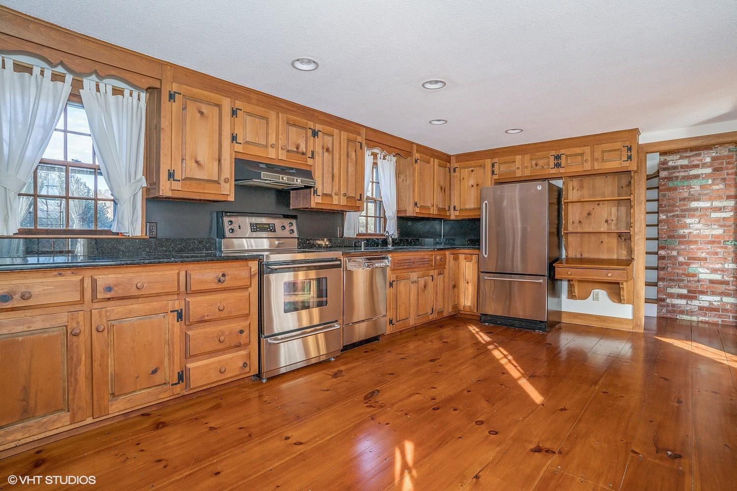 26 Point Hill Road West Barnstable, MA 02668 - Photo 7 of 23 a kitchen with stainless steel appliances granite countertop a refrigerator sink and cabinets