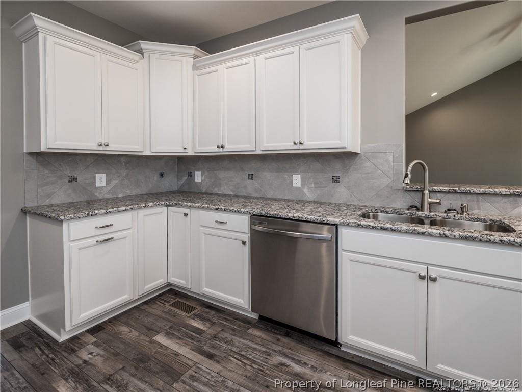 1102 West Carthage Road Lumberton, NC 28360 - Photo 11 of 41 a kitchen with granite countertop white cabinets and white appliances
